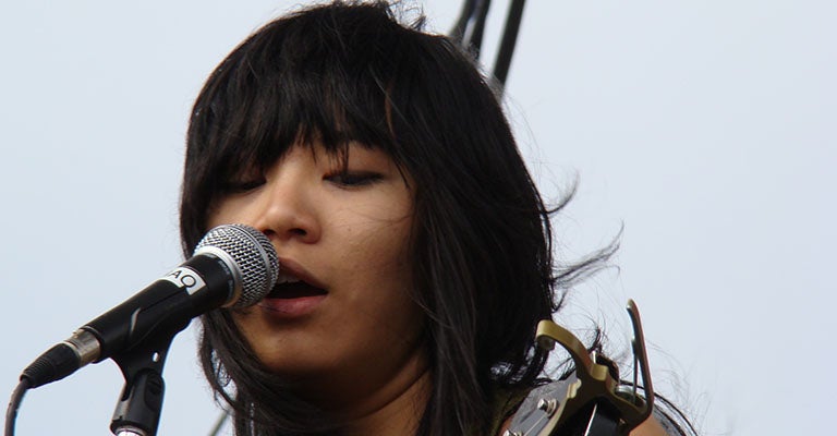 Singer-songwriter Thao Nguyen, pictured playing guitar, is one of the headliners at the DC Talks Music/FilmDocs/Media Conference.