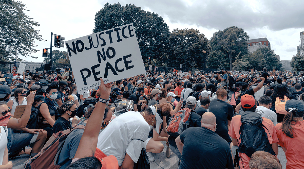 Photo by Clay Banks, Unsplash, group of people kneeling at protest