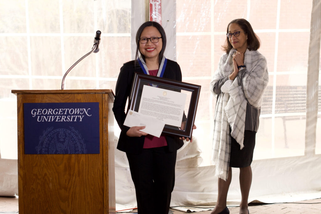 Professor Presores smiles while receiving her award for excellence in instruction. 