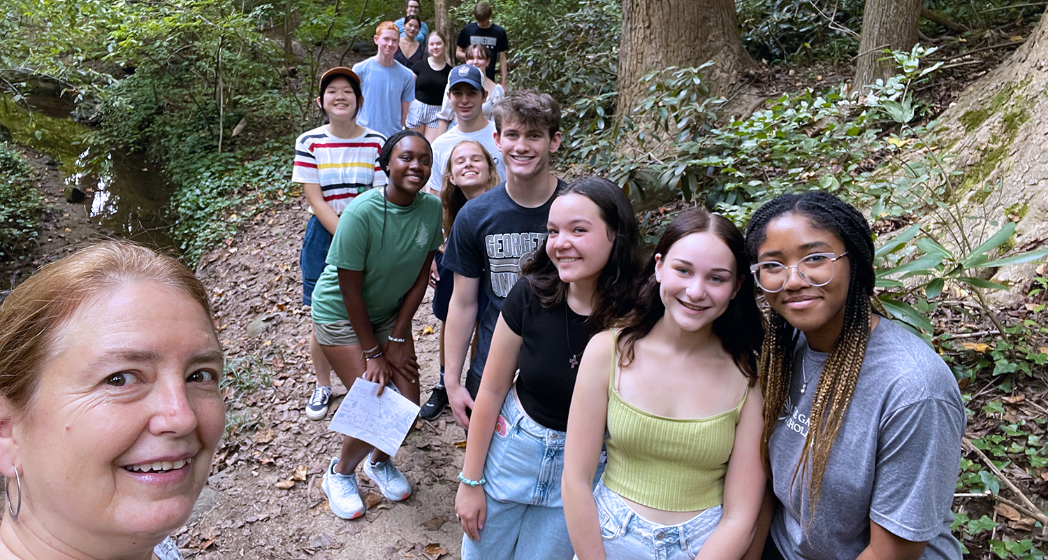 Students on a trip - group pictured walking in a wooded area