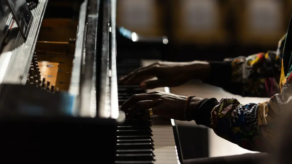 A close-up shot of a man's hands playing the piano.