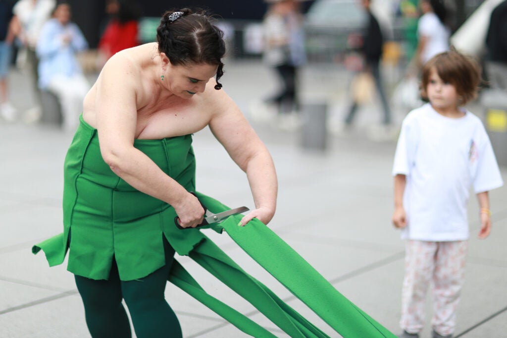 The performer cutting the dress extensions. 