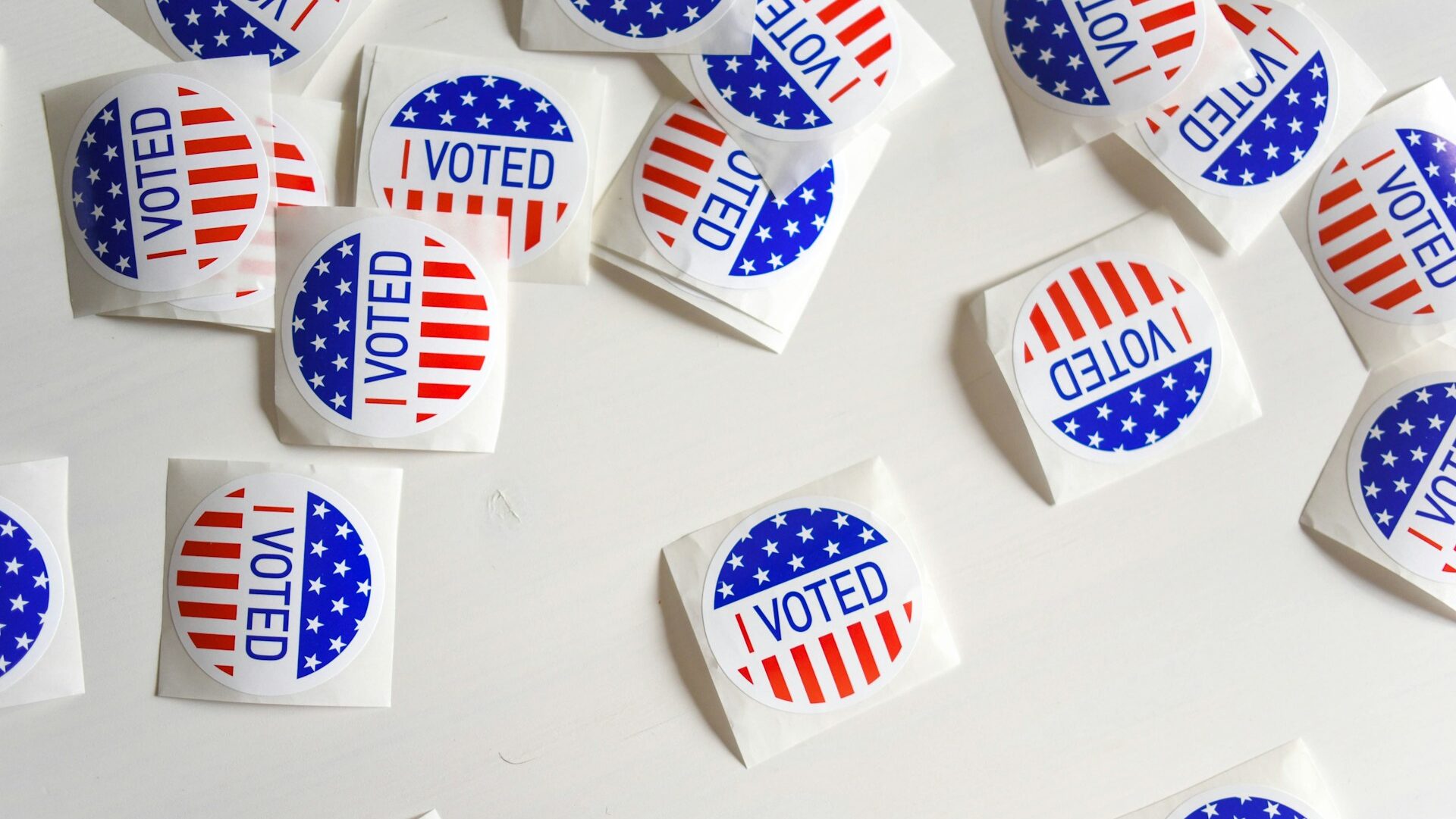 A cluster of red, white, and blue stickers reading 