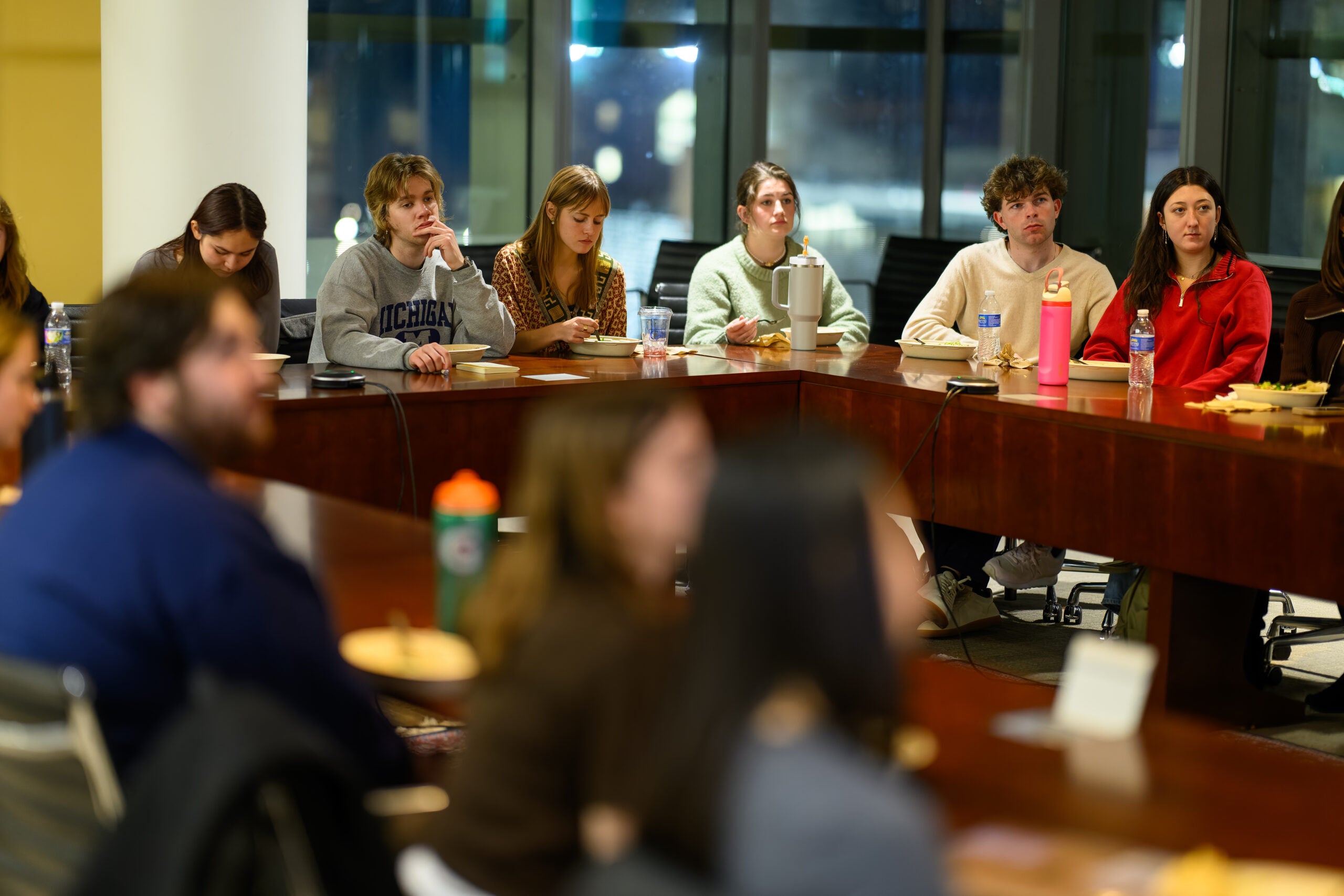 SRN students around a table at a lecture