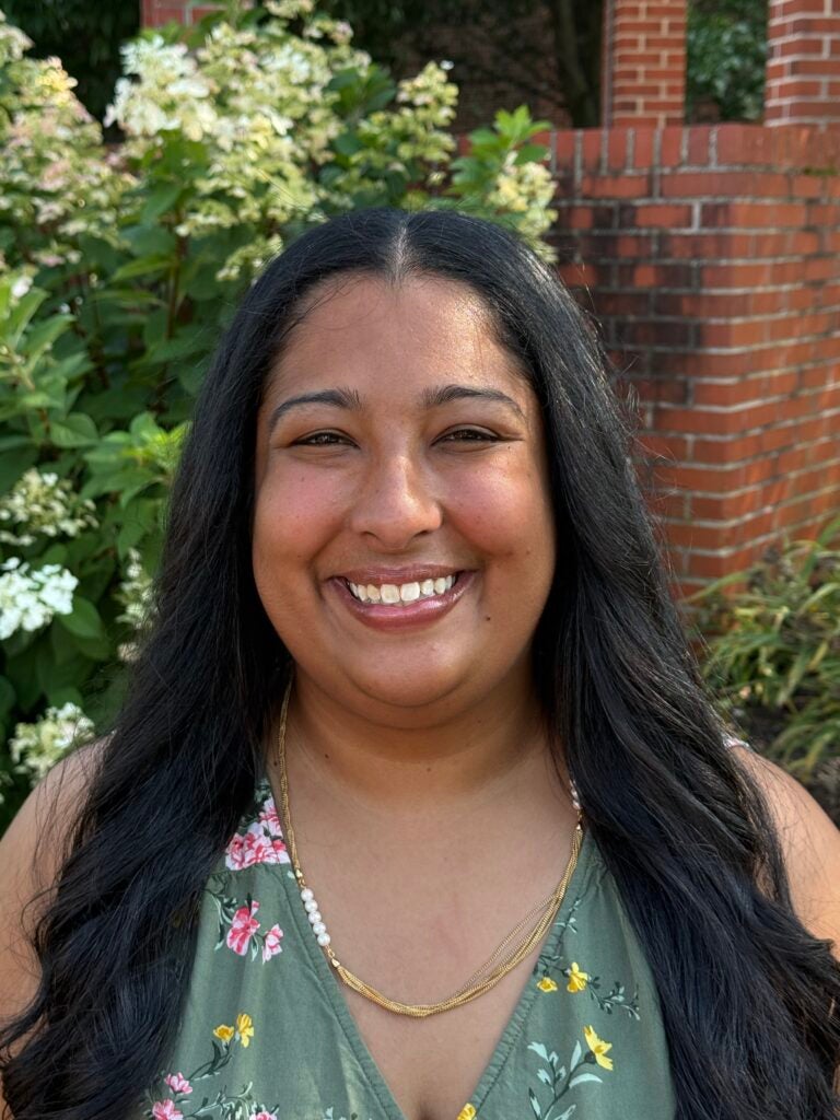 A woman smiling at the camera for a headshot.