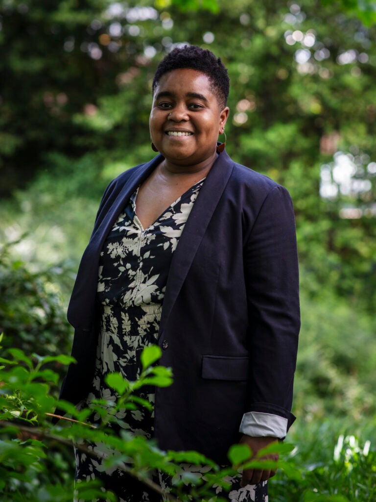 Portrait of a professor wearing a jacket and floral shirt, smiling