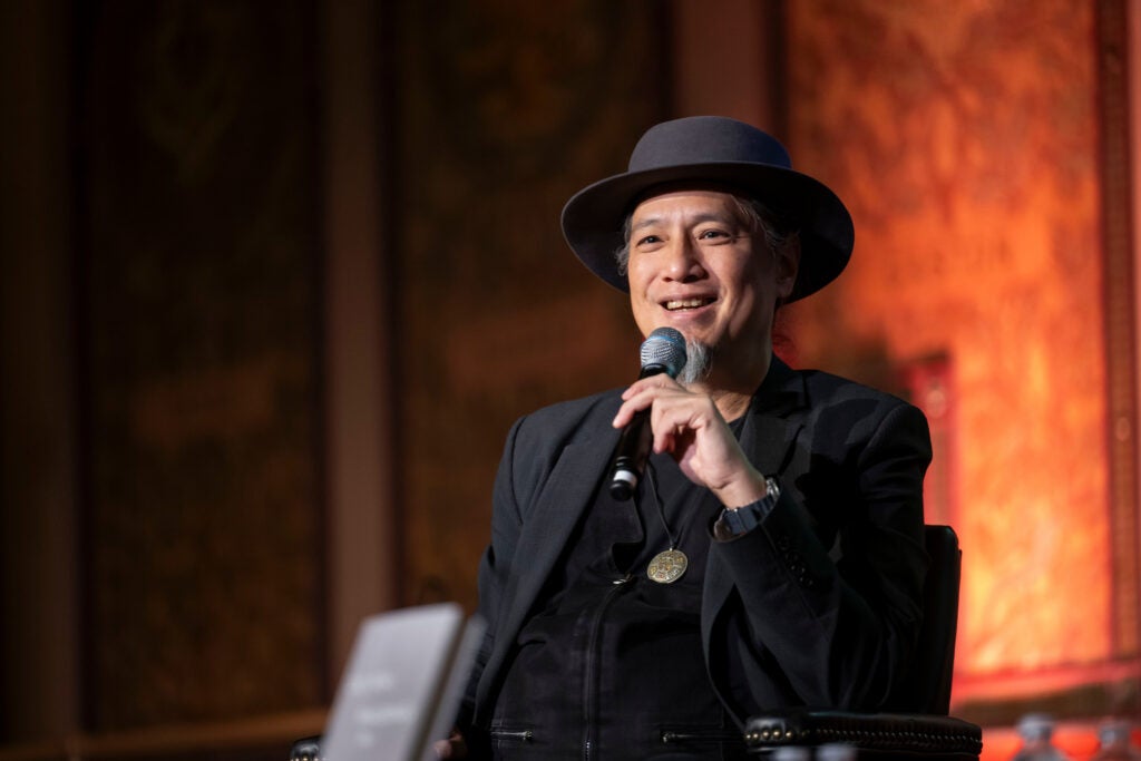 De Kai smiling while addressing a crowd at Georgetown University