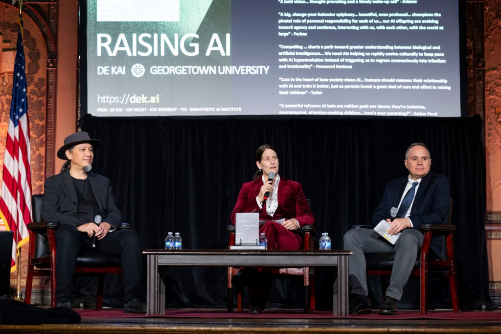 Three panelists sitting together at a Georgetown University event 