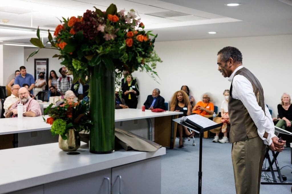 A professor looks on while giving remarks during the opening reception of his exhibit at Georgetown University’s Lauinger Library.