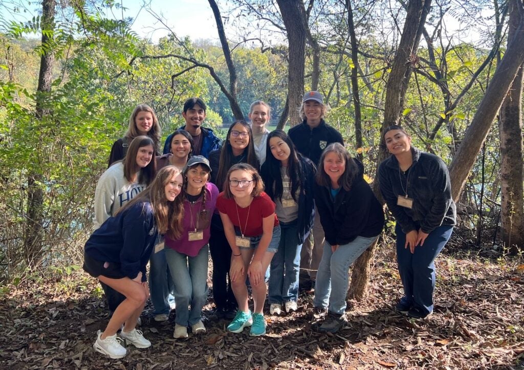 A group of people posing outside in front of the Potomac River at the Yankauer Nature Preserve.