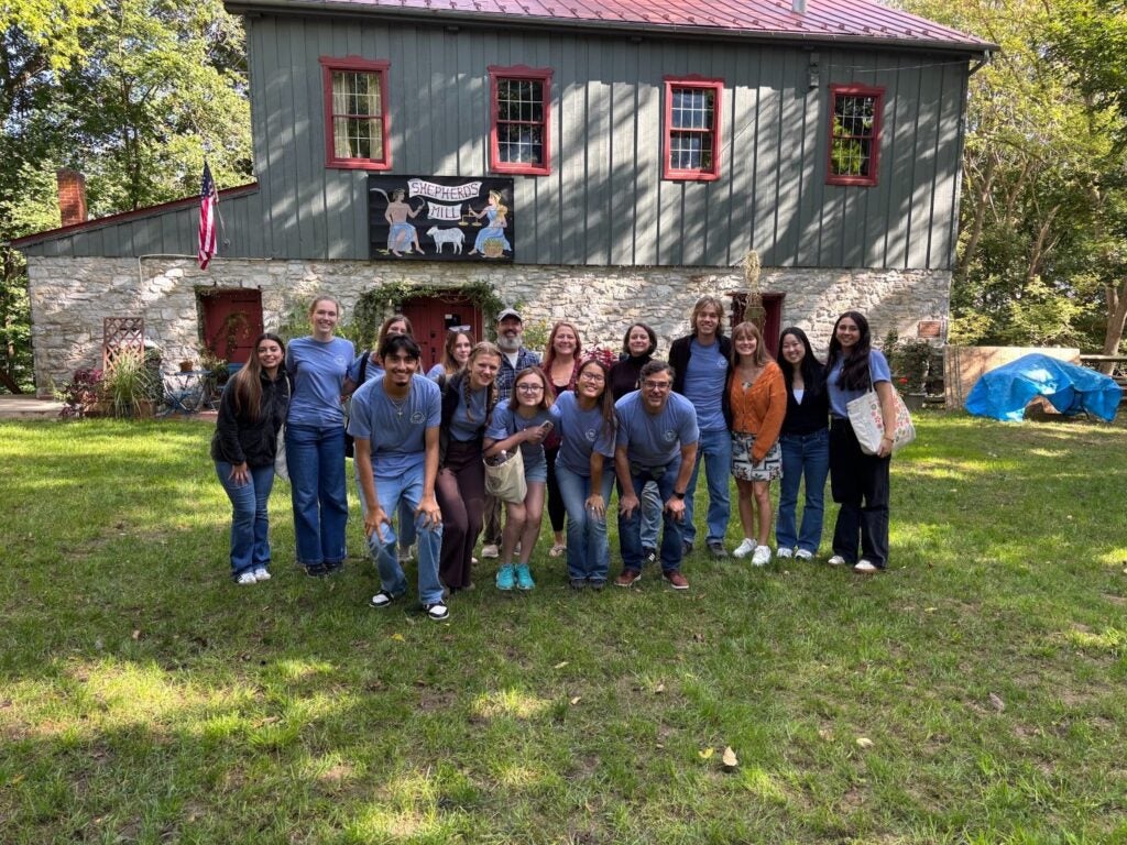 A group poses in front of the Thomas Sehpherd Grist Mill in Shepherdstown, West Virginia