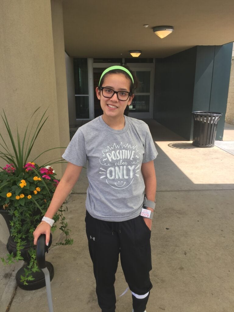 A stroke survivor patient uses a cane for support