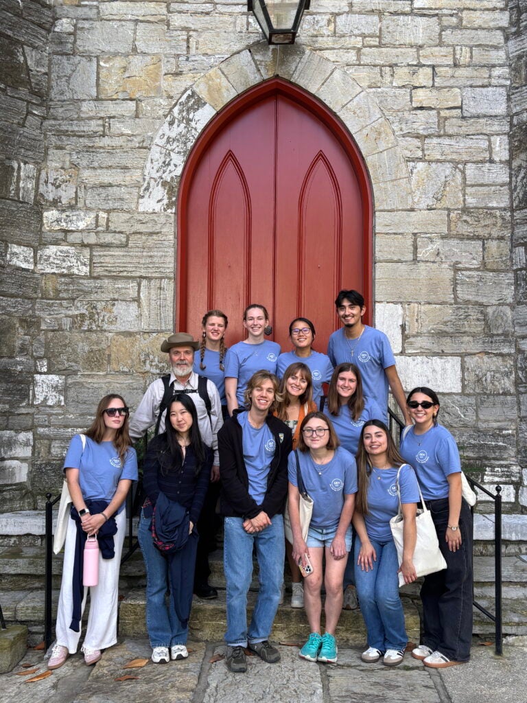 A group poses in front of the historic Trinity Episcopal Church in Shepherdstown, West Virginia
