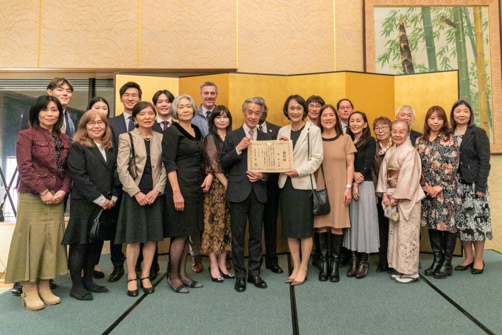 A group of people at an award ceremony at the Residence of the Ambassador of Japan.