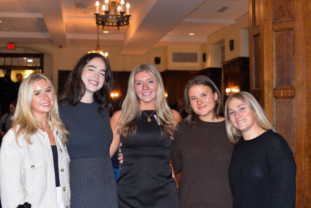 A graduating Georgetown student in the center surrounded by four of her friends.