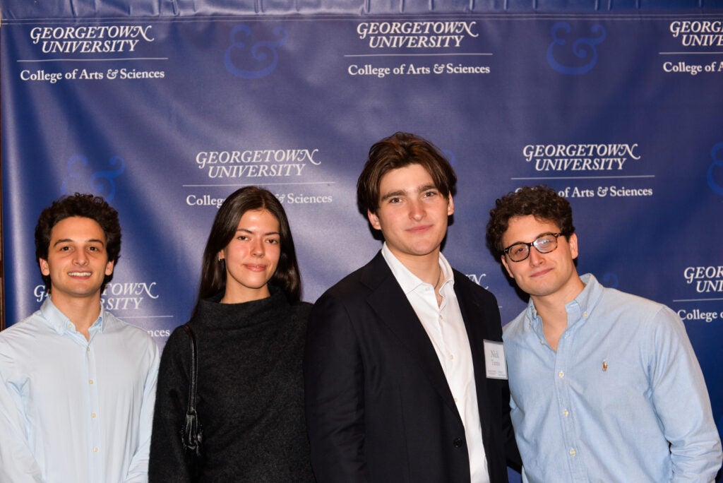 A graduating senior with his friends and girlfriend.