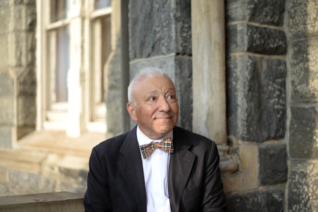 A professor wearing a bowtie and suit jacket looking off camera
