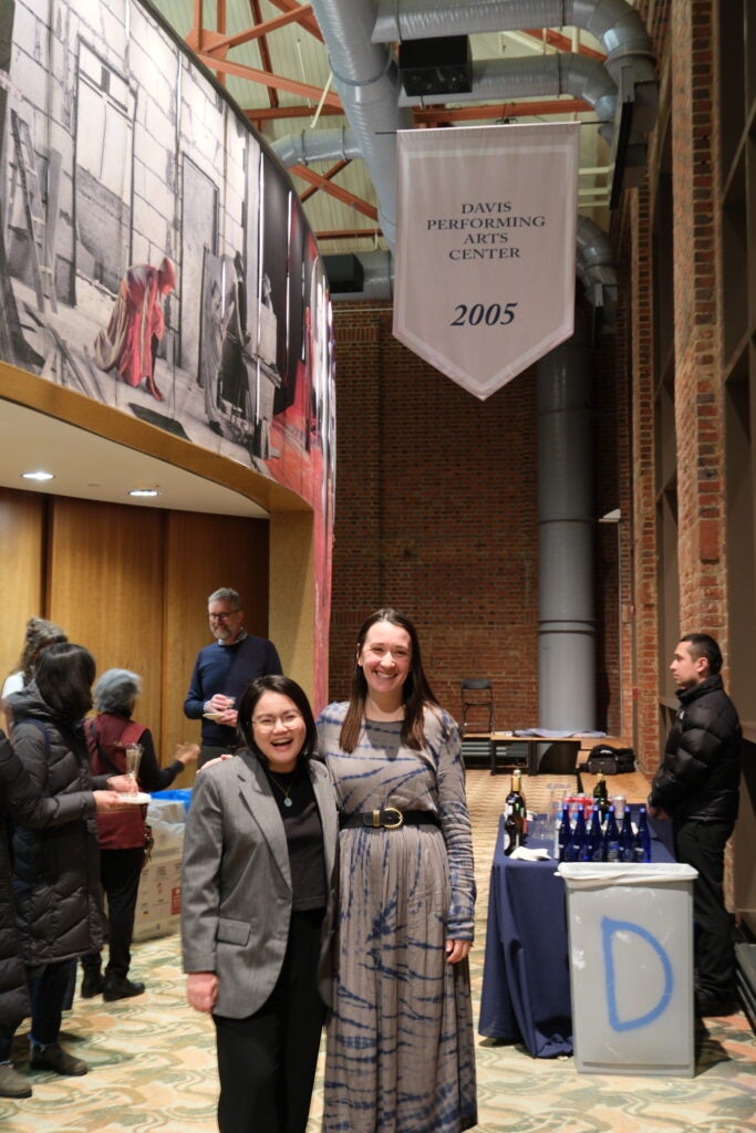 A professor and her exhibition co-curator pose before a performance in Davis Performing Arts Center