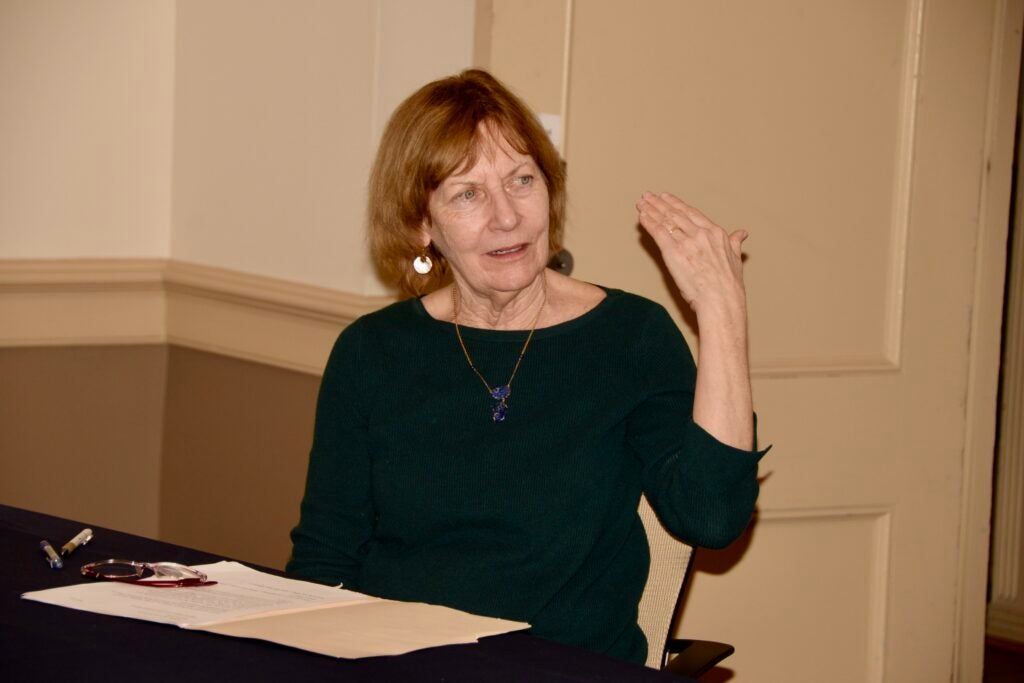 An English professor mid-conversation during a panel discussion