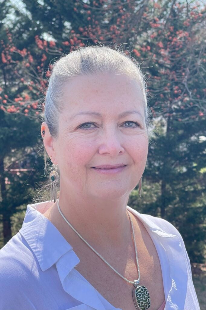 A professor of Chemistry smiling for a headshot