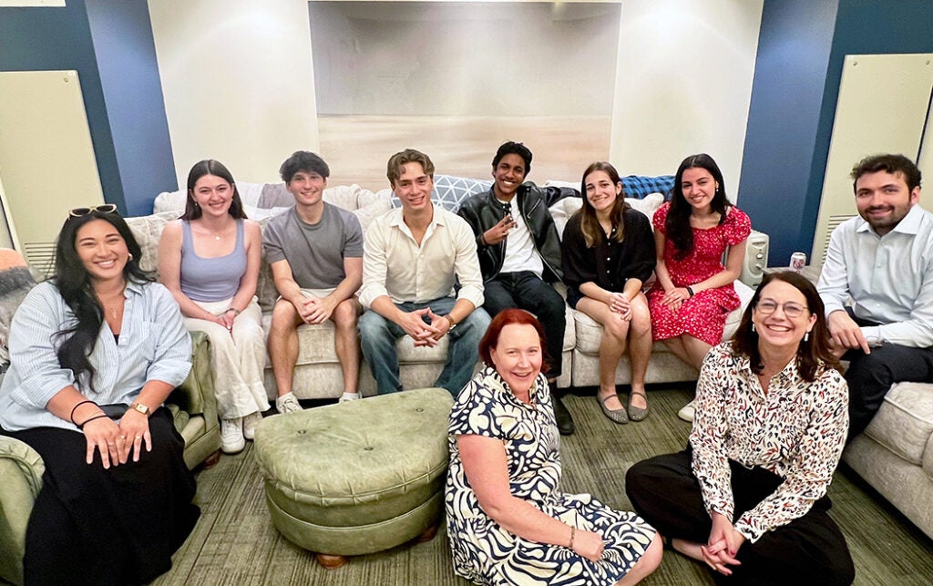 Students and faculty sitting in a lounge