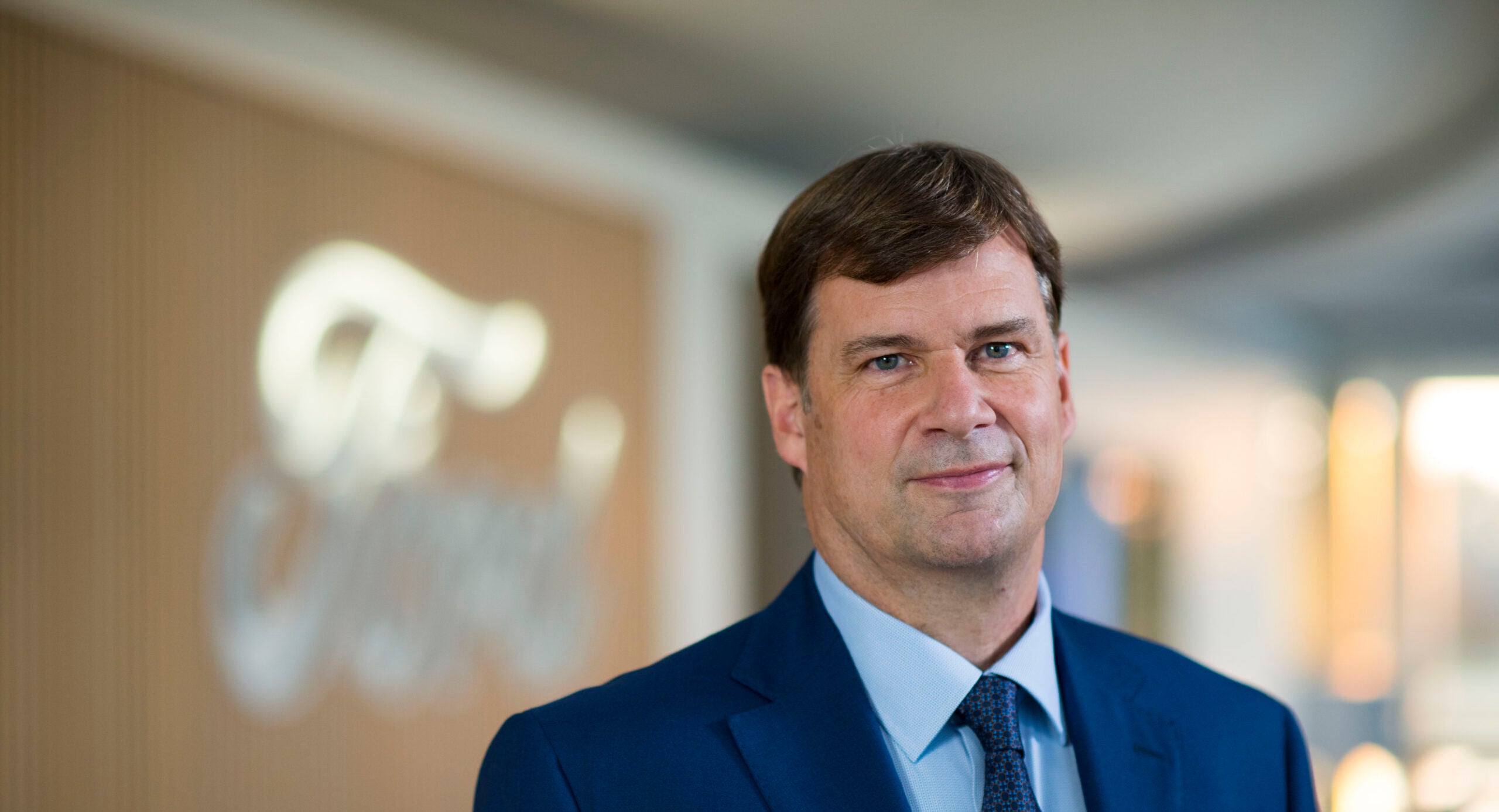 The Ford CEO wearing a suit and tie smiling