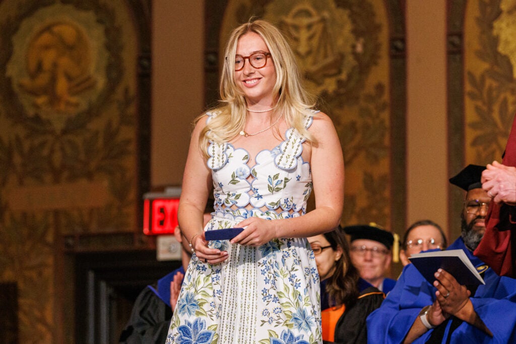 A graduating senior walking on stage after winning an award
