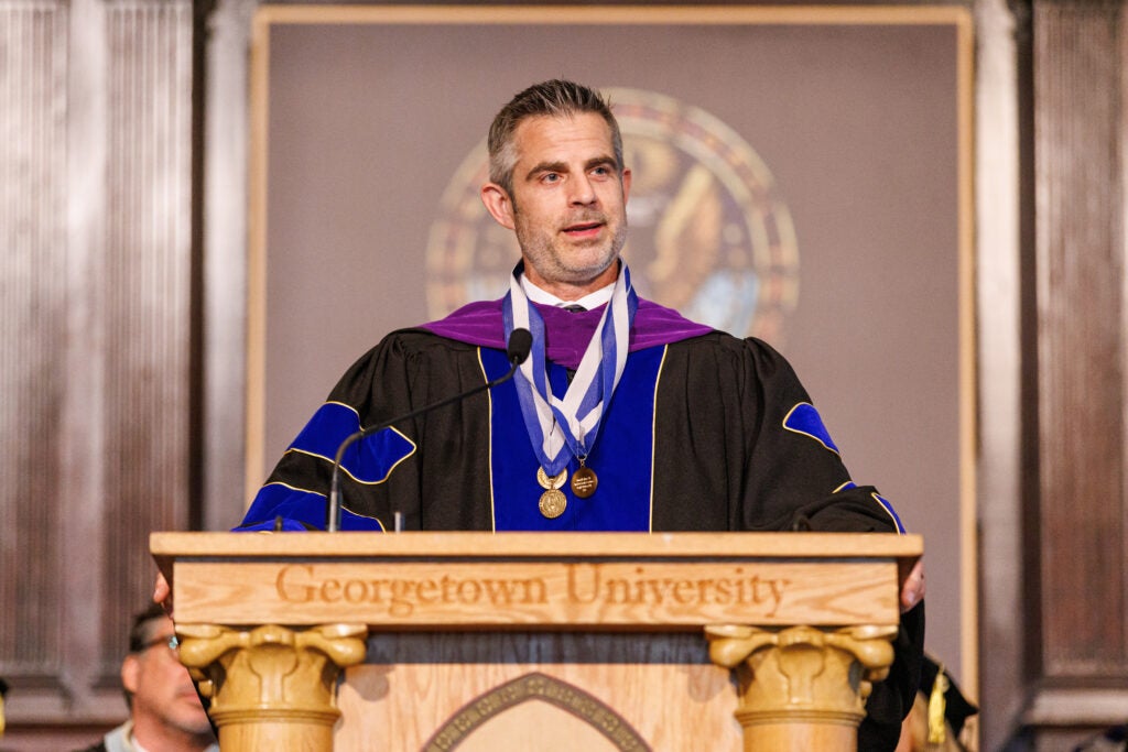 A professor giving a speech behind a podium