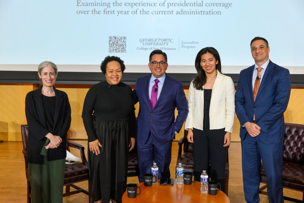 A journalism professor and guests on stage at Lohrfink Auditorium
