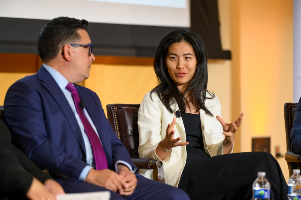 Two panelists talking at an event in Lohrfink Auditorium