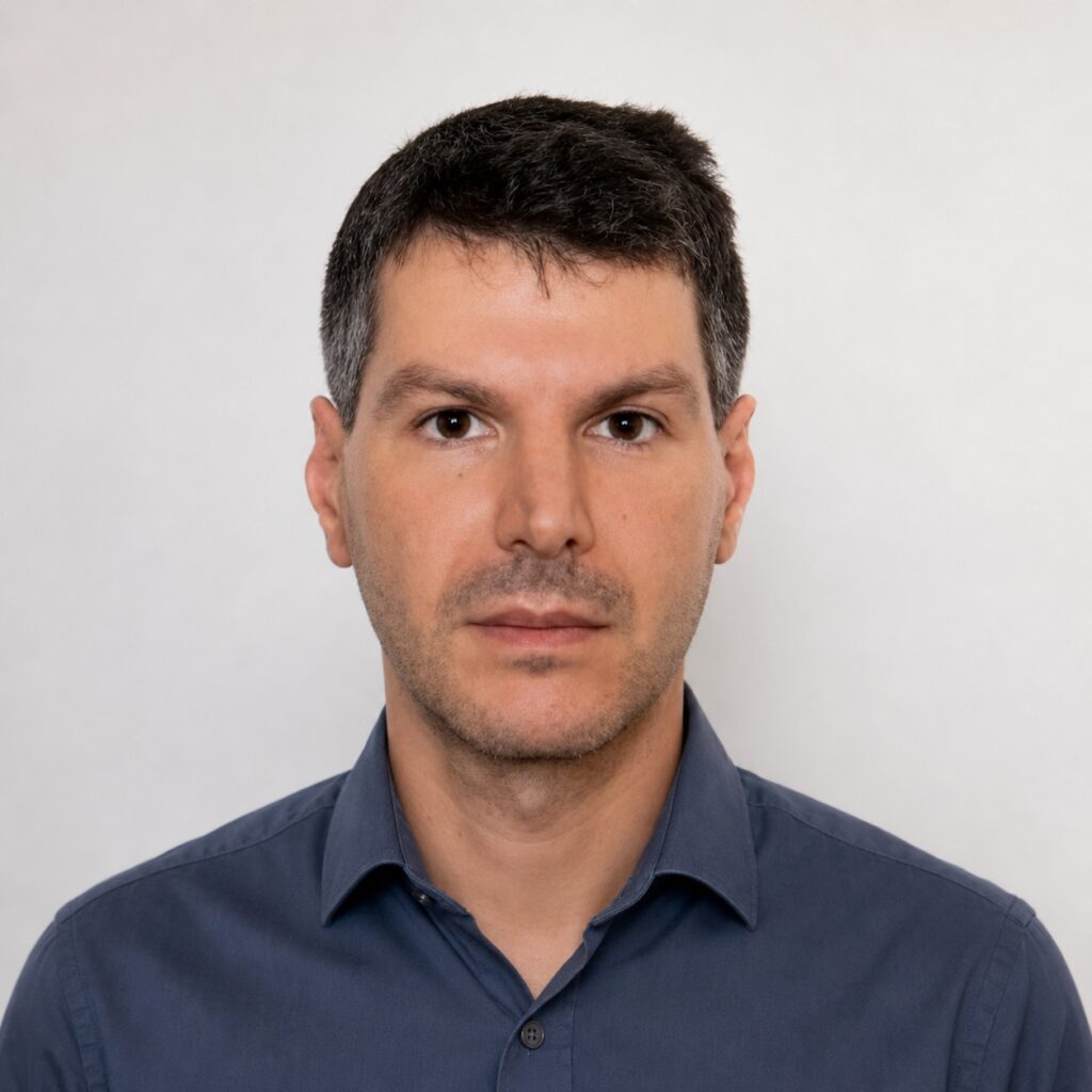 Headshot of a Georgetown University professor in front of a white background.
