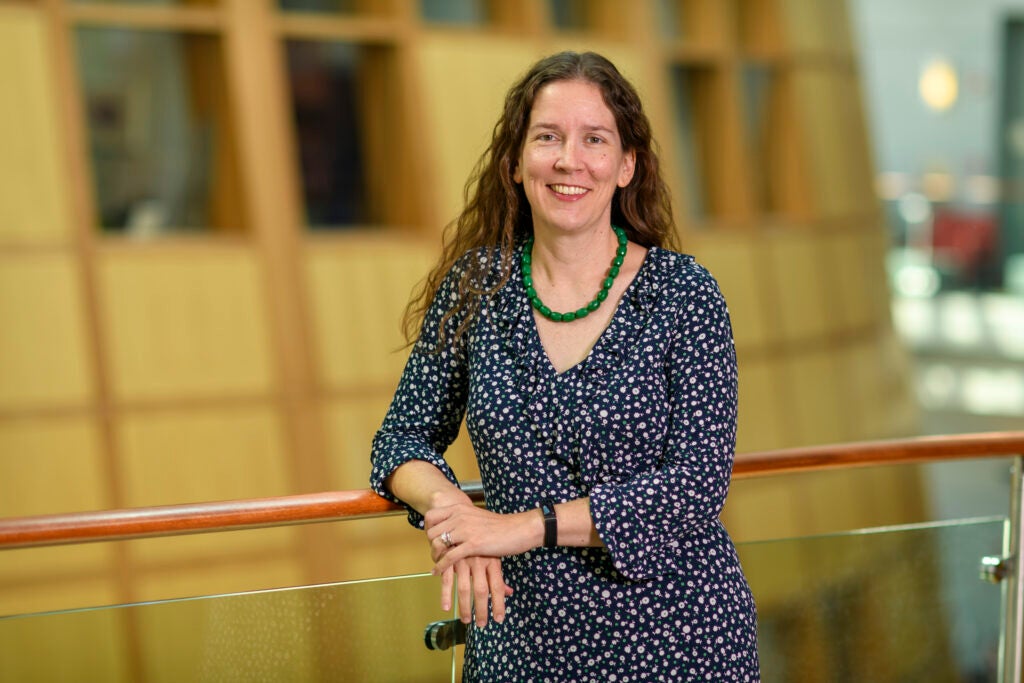 Headshot of a Georgetown University administrator smiling in front of a blurred background.