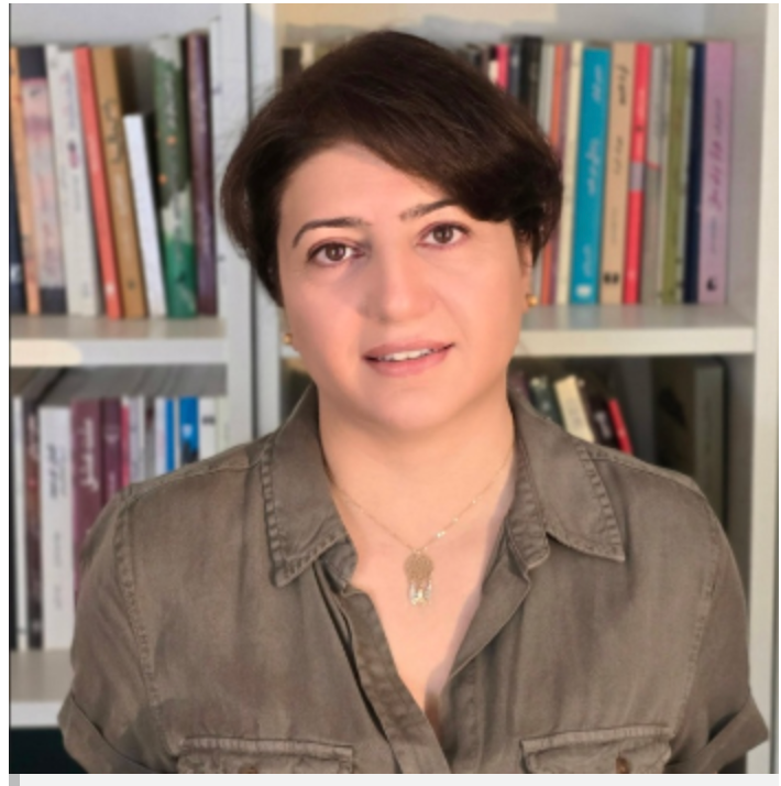 Headshot of a Georgetown University professor posing in front of a bookshelf.