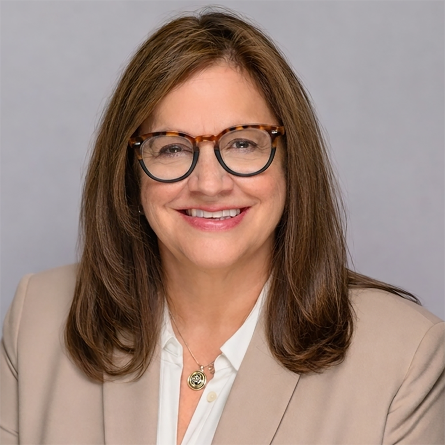 Headshot of a smiling Georgetown University professor wearing glasses.