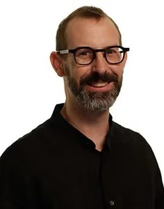 A headshot of a smiling Georgetown University professor.